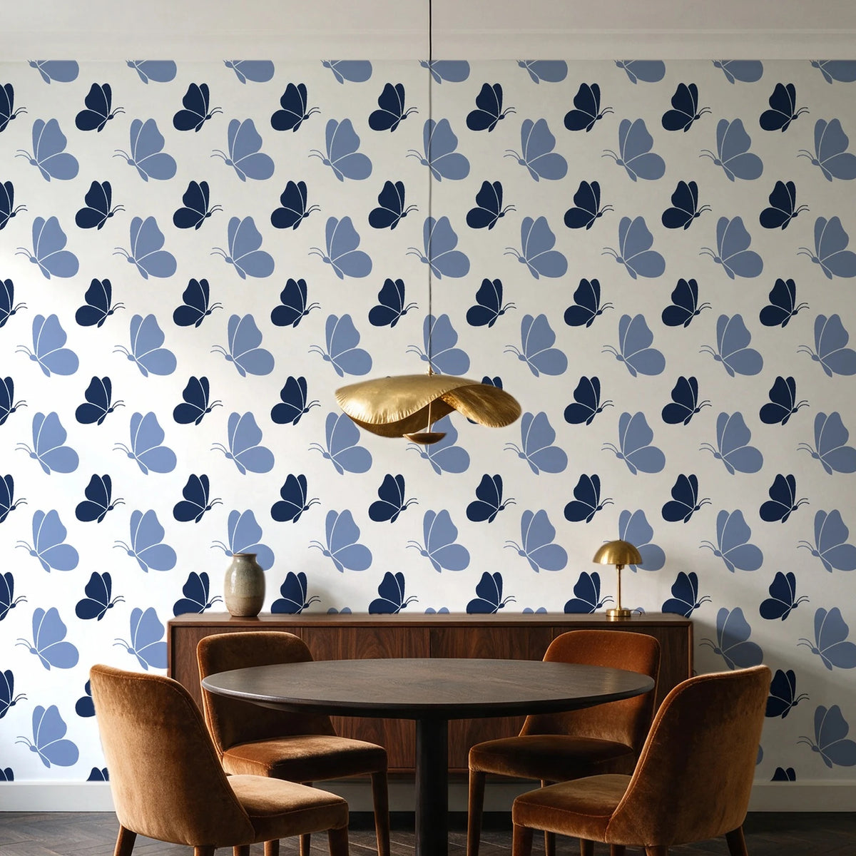 Dust & Wing Navy butterflies wallpaper behind a walnut credenza and round table in an elegant dining room