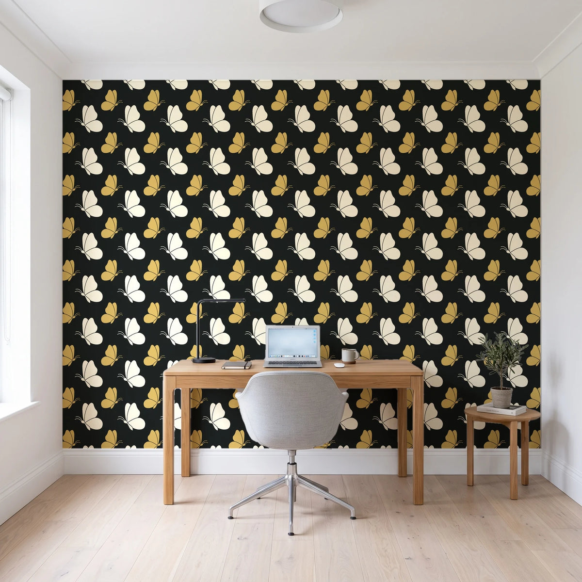 Dust & Wing Onyx butterflies wallpaper behind a modern oak desk in a bright home office