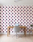 Dust & Wing Plum butterflies wallpaper behind a modern oak desk in a bright home office