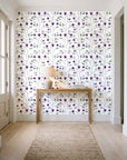 Ember & Leaf Aubergine botanical floral wallpaper behind a console table in a light entry hallway