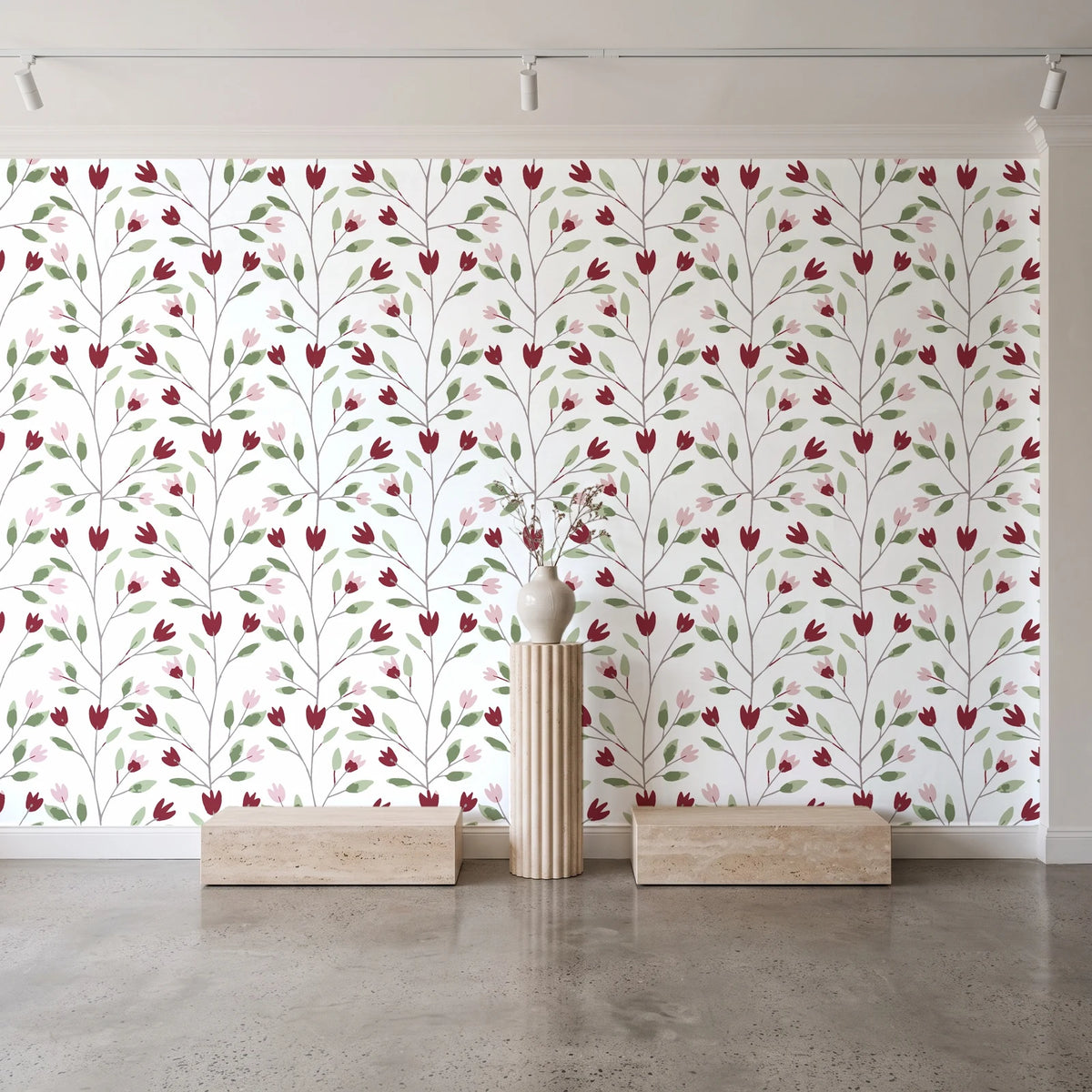 Ember & Leaf Garnet botanical floral wallpaper behind a travertine pedestal and vase in a minimal boutique