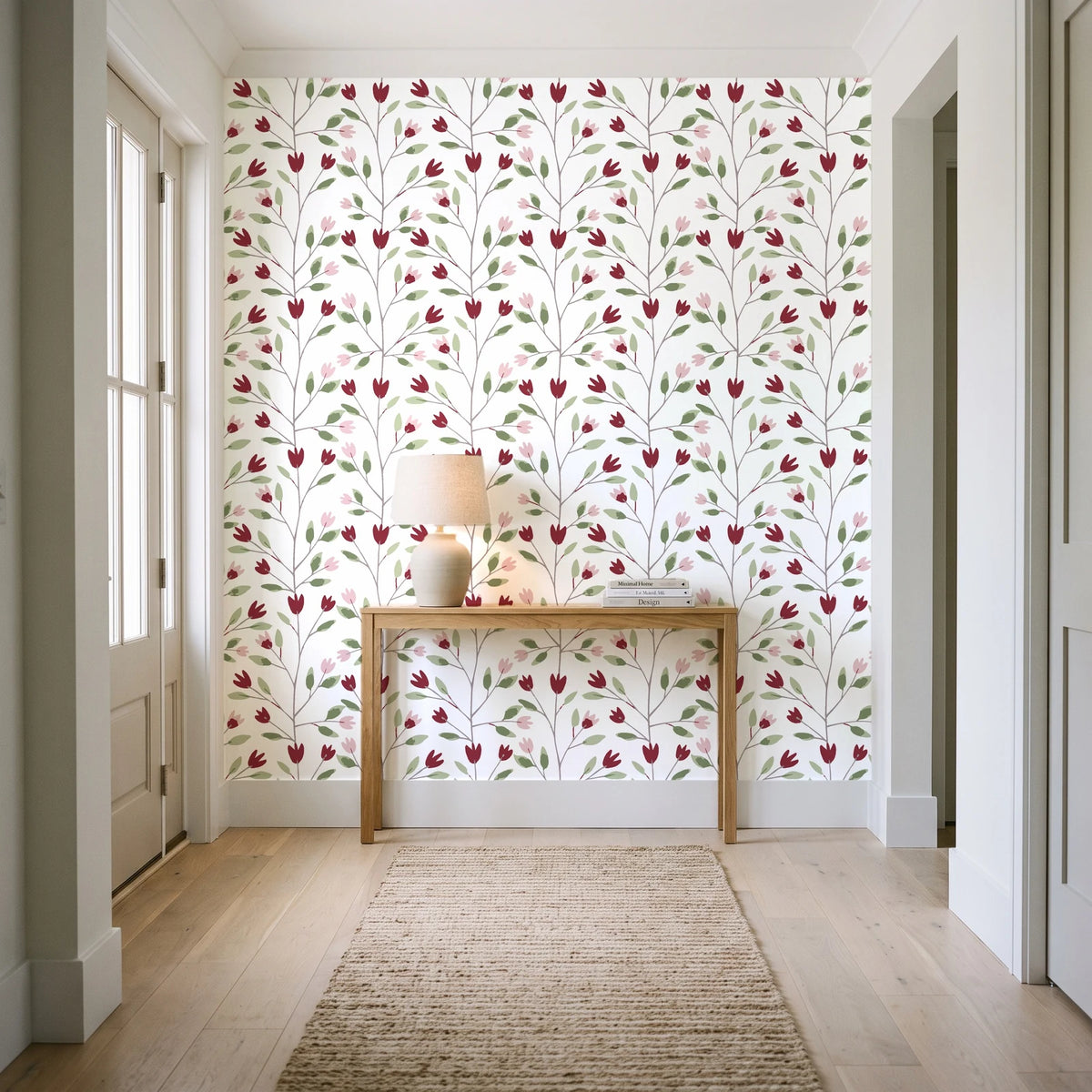 Ember & Leaf Garnet botanical floral wallpaper behind a console table in a light entry hallway