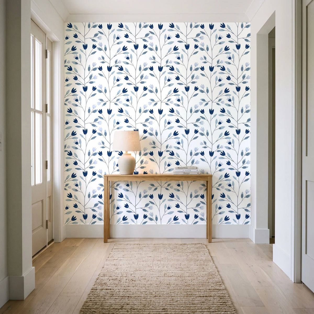 Ember & Leaf Midnight botanical floral wallpaper behind a console table in a light entry hallway