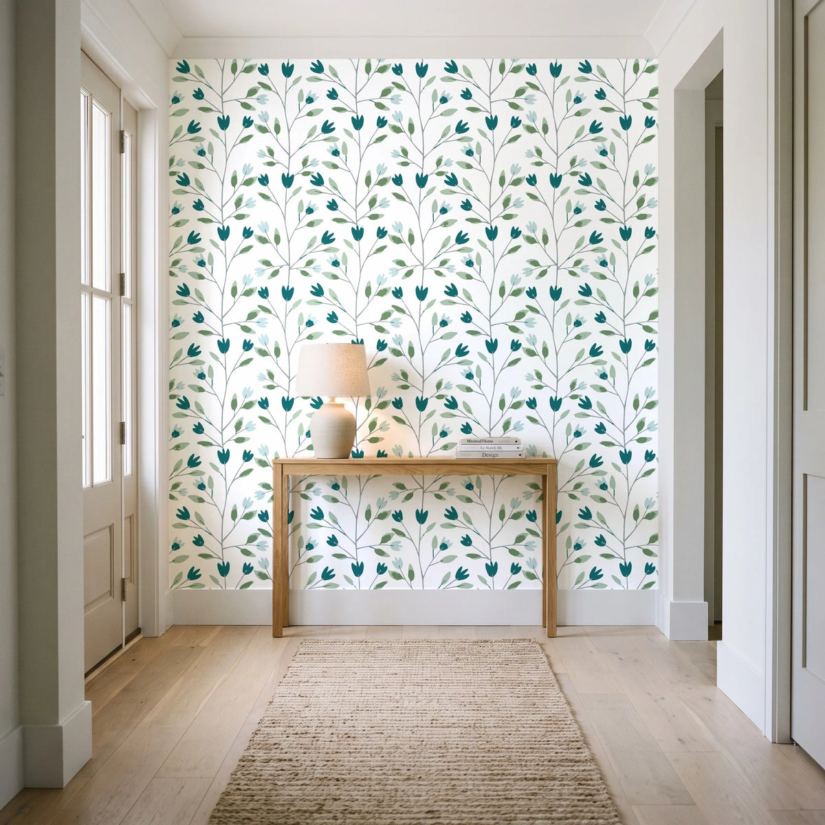 Ember & Leaf Peacock botanical floral wallpaper behind a console table in a light entry hallway
