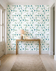 Ember & Leaf Peacock botanical floral wallpaper behind a console table in a light entry hallway