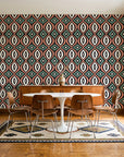 Ember & Iron Forest retro ogee wallpaper in a mid-century dining room with a teak sideboard and tulip table