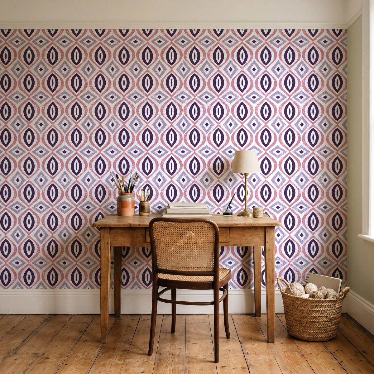 Ember & Iron Plum retro ogee wallpaper behind a vintage writing desk in a cozy craft-room home office