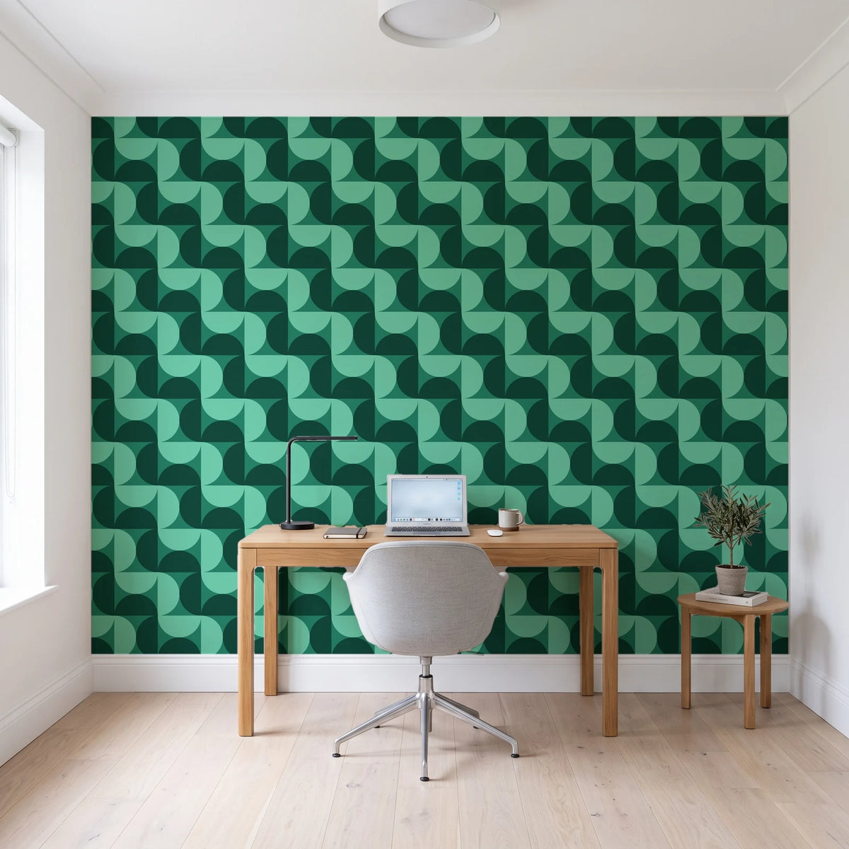 Ember Mosaic Emerald retro geometric wallpaper behind a modern oak desk in a bright home office