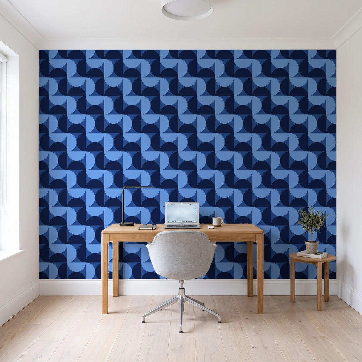 Ember Mosaic Midnight retro geometric wallpaper behind a modern oak desk in a bright home office