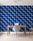 Ember Mosaic Midnight retro geometric wallpaper behind a modern oak desk in a bright home office