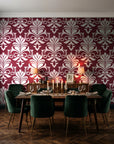 Ethereal Flowers Garnet damask wallpaper in a dark moody dining room with a candlelit table
