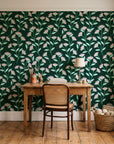 Evening Garden Forest botanical floral wallpaper behind a vintage writing desk in a cozy craft-room home office