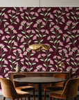 Evening Garden Oxblood botanical floral wallpaper behind a walnut credenza and round table in an elegant dining room