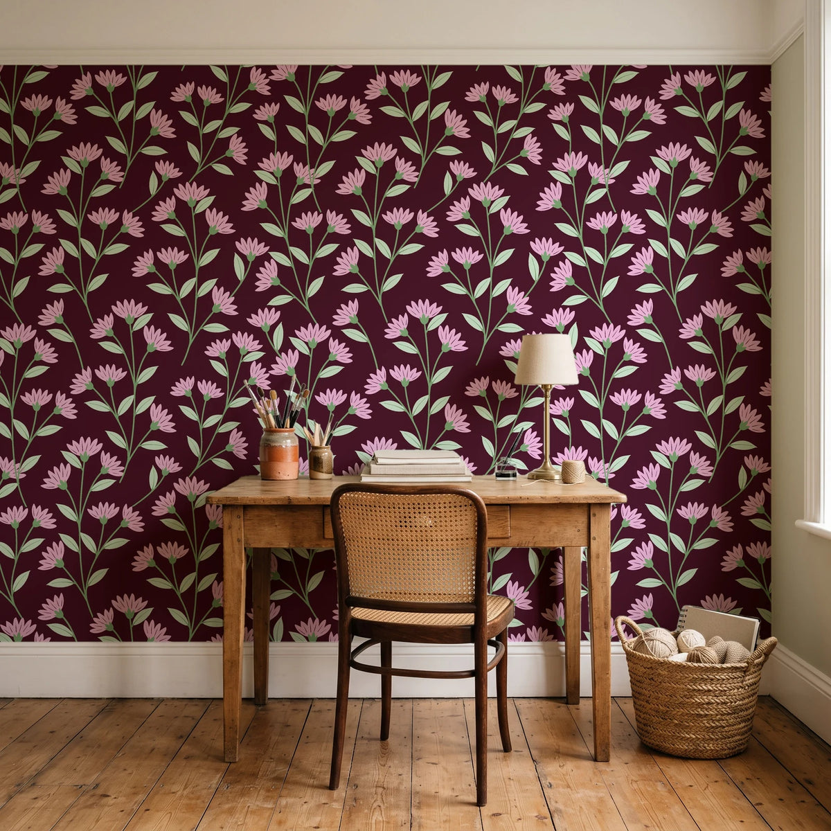 Evening Garden Oxblood botanical floral wallpaper behind a vintage writing desk in a cozy craft-room home office