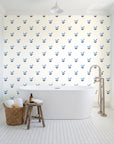 Falling Grace Navy chevron wallpaper behind a freestanding tub in a bright coastal bathroom