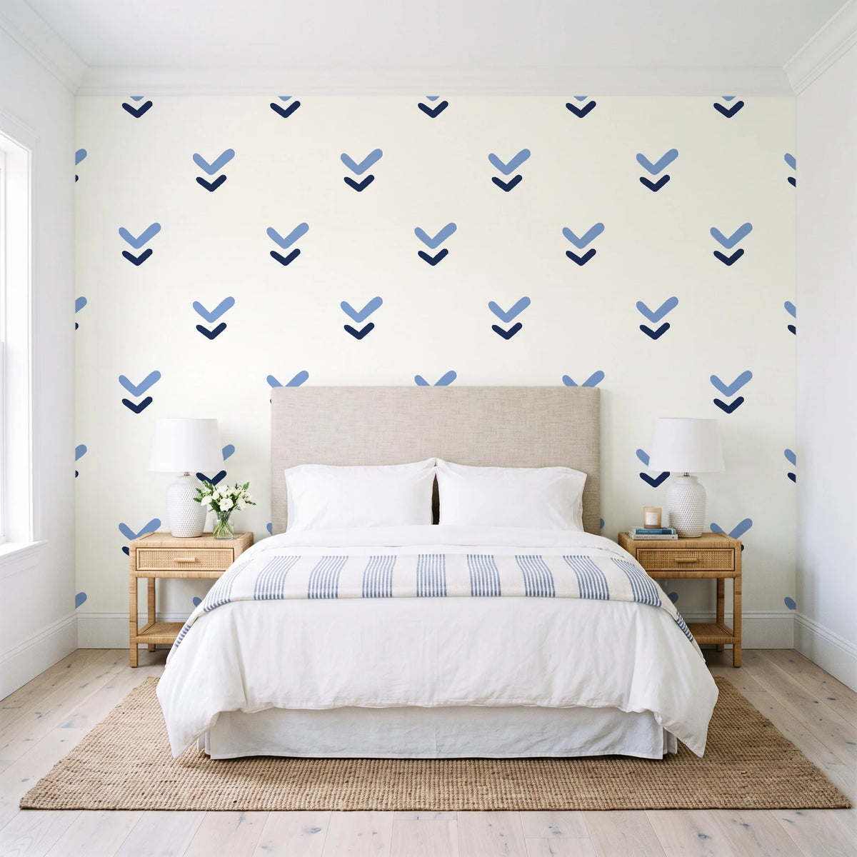 Falling Grace Navy chevron wallpaper behind a queen bed in a bright coastal bedroom