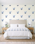 Falling Grace Navy chevron wallpaper behind a queen bed in a bright coastal bedroom