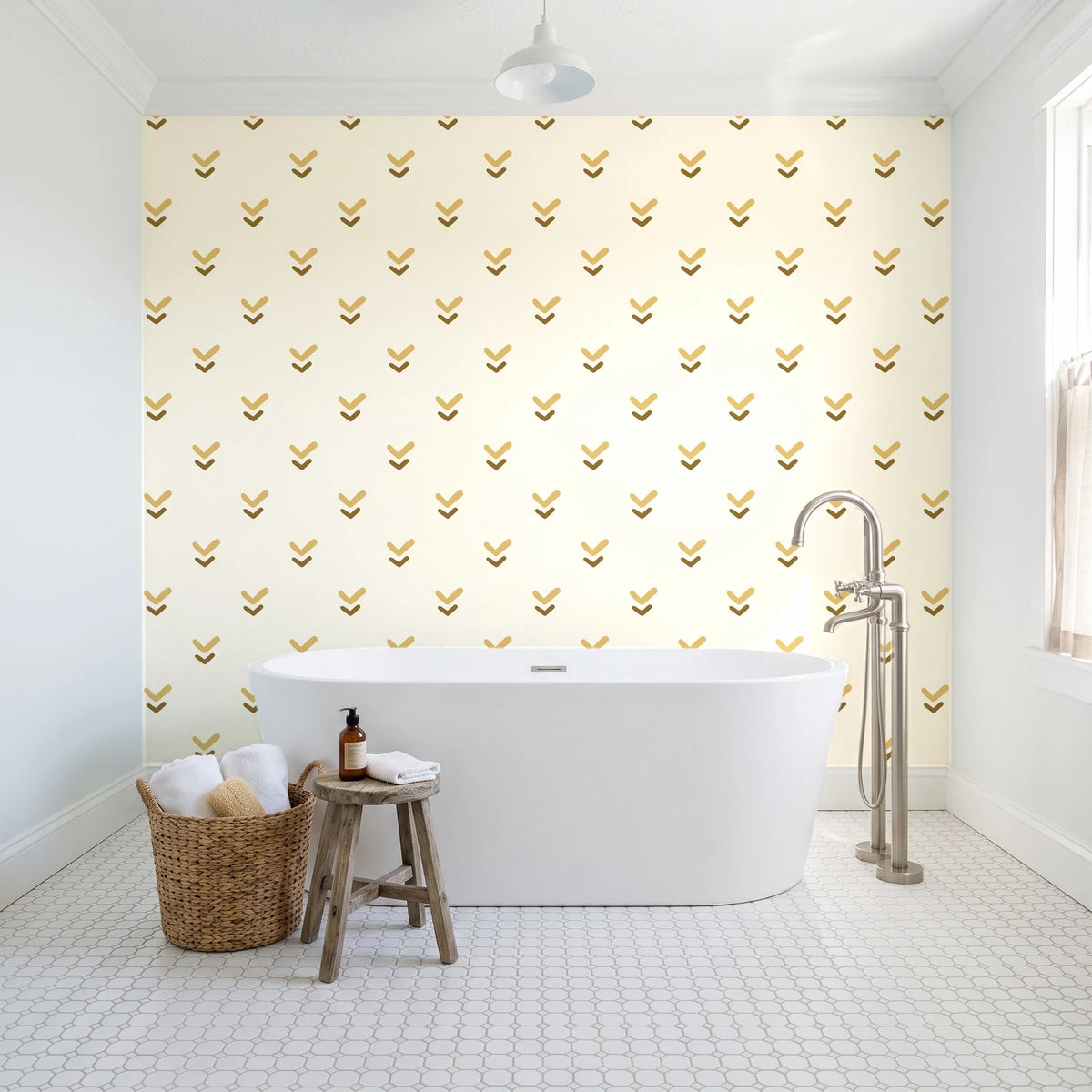 Falling Grace Ochre chevron wallpaper behind a freestanding tub in a bright coastal bathroom