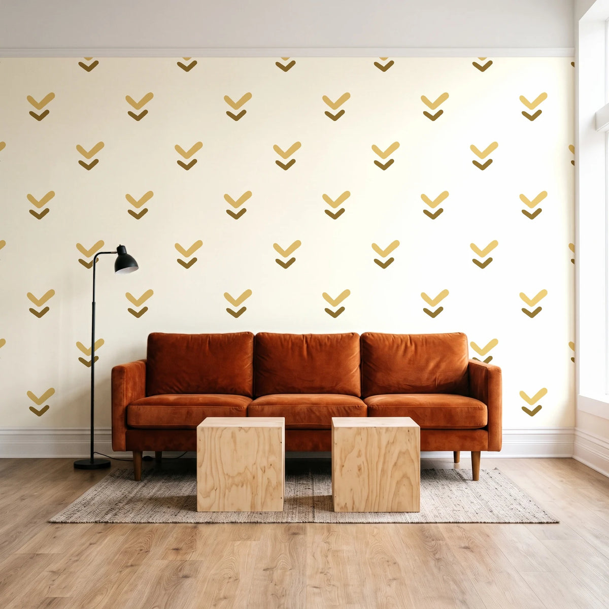 Falling Grace Ochre chevron wallpaper behind a rust velvet sofa in a bright coworking lounge
