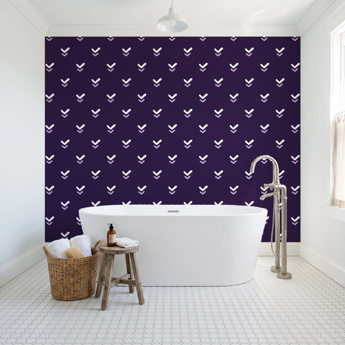 Falling Grace Plum chevron wallpaper behind a freestanding tub in a bright coastal bathroom
