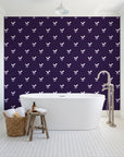 Falling Grace Plum chevron wallpaper behind a freestanding tub in a bright coastal bathroom