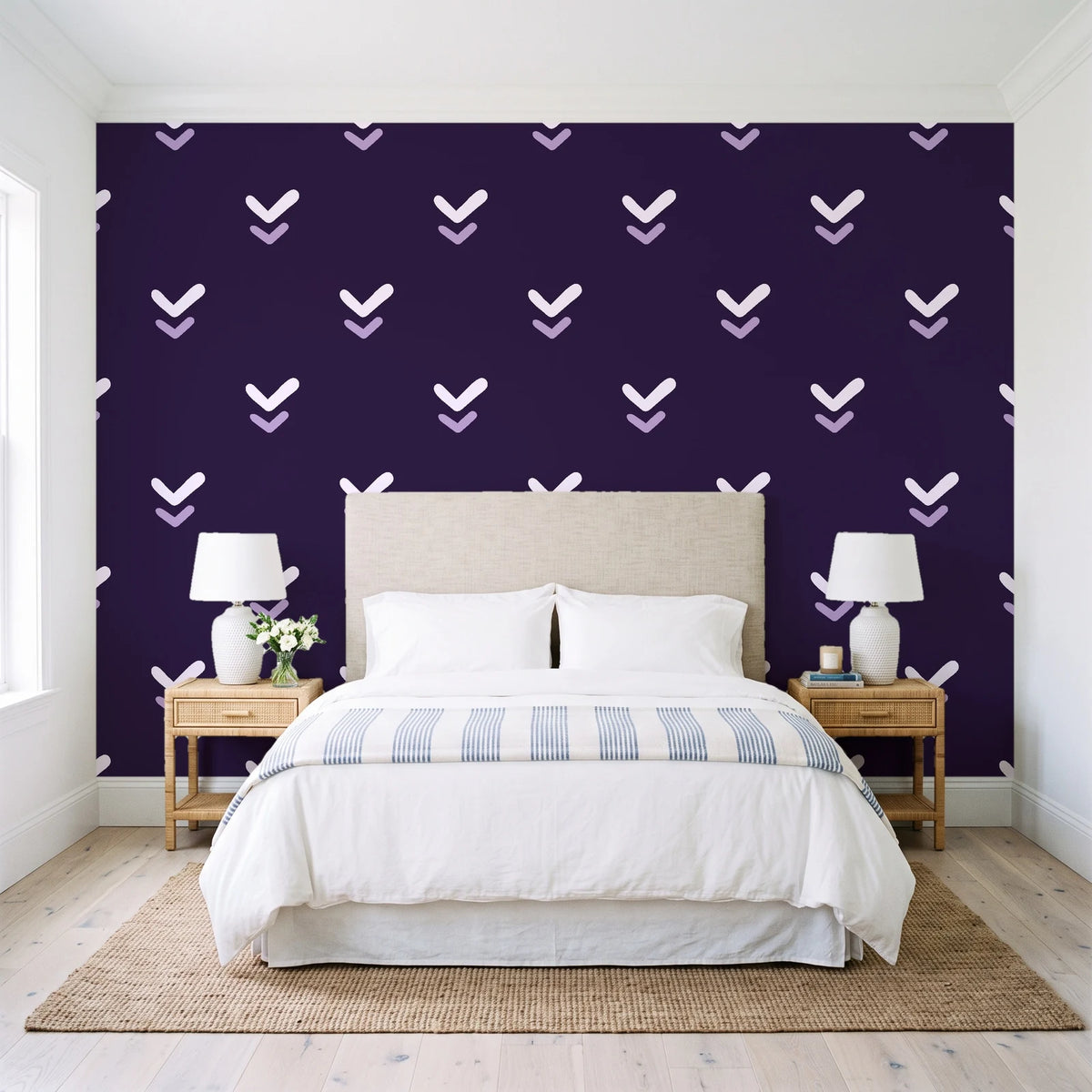 Falling Grace Plum chevron wallpaper behind a queen bed in a bright coastal bedroom
