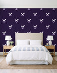 Falling Grace Plum chevron wallpaper behind a queen bed in a bright coastal bedroom