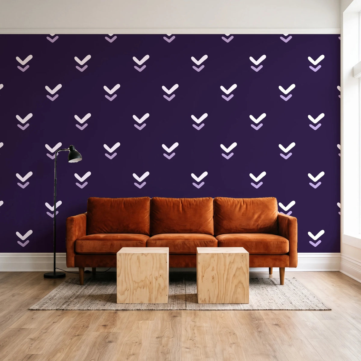 Falling Grace Plum chevron wallpaper behind a rust velvet sofa in a bright coworking lounge