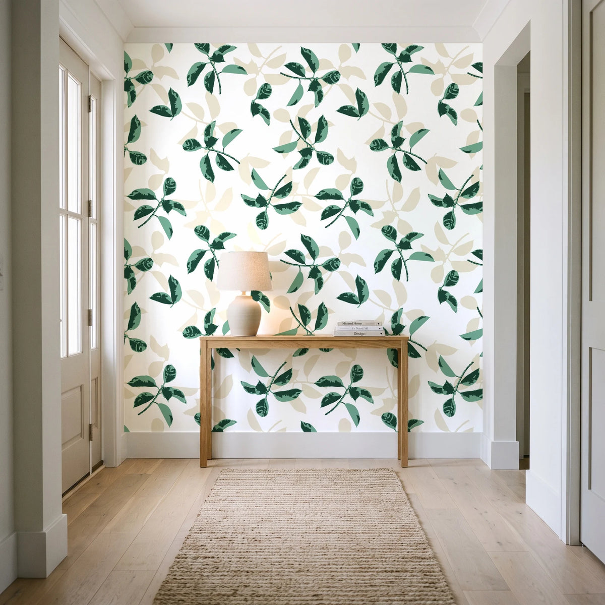 Falling Softly Emerald botanical leaf wallpaper behind a console table in a light entry hallway