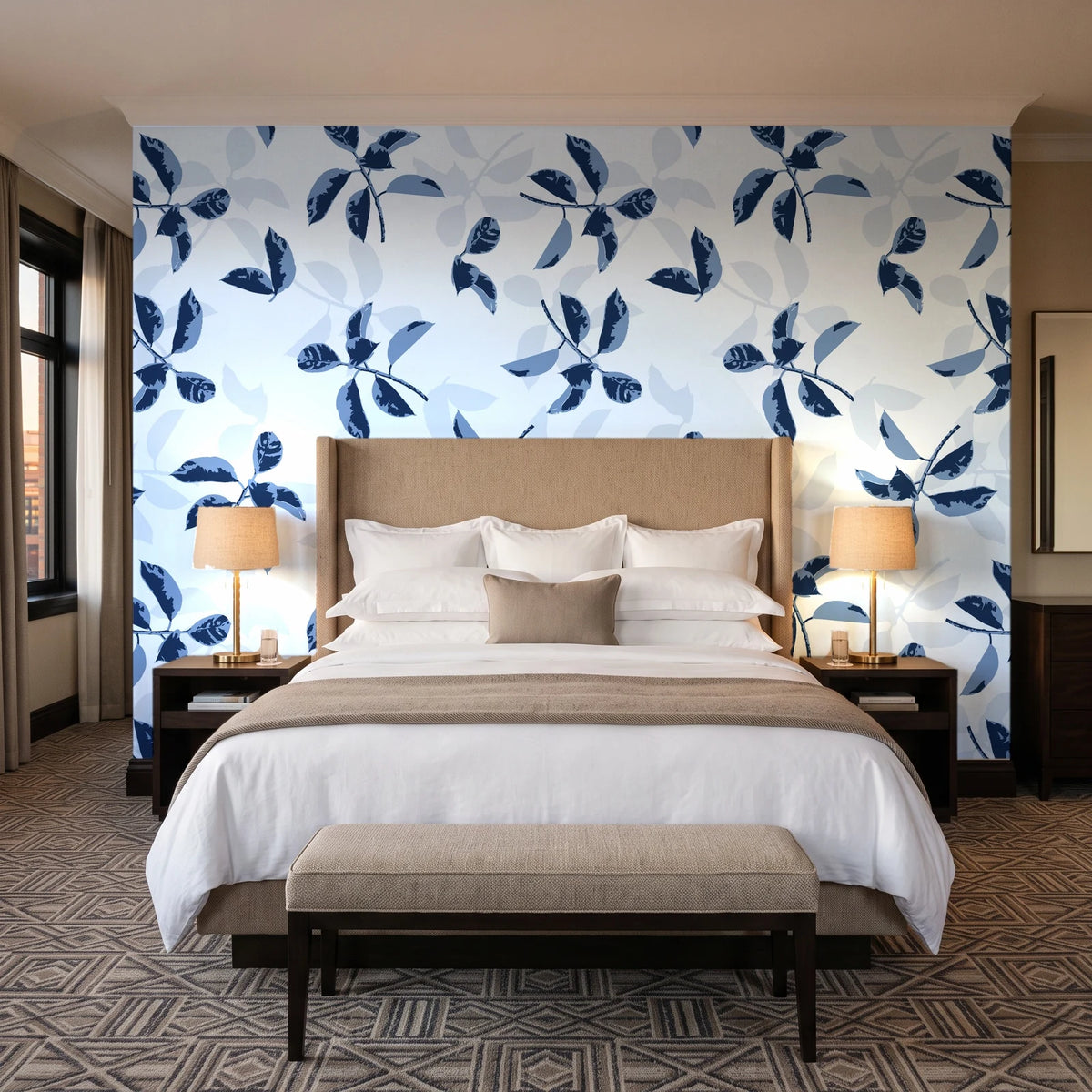 Falling Softly Navy botanical leaf wallpaper behind the headboard of a king bed in a contemporary hotel guest room