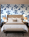 Falling Softly Navy botanical leaf wallpaper behind the headboard of a king bed in a contemporary hotel guest room