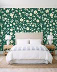 First Bloom Emerald ditsy floral wallpaper behind a queen bed in a bright coastal bedroom