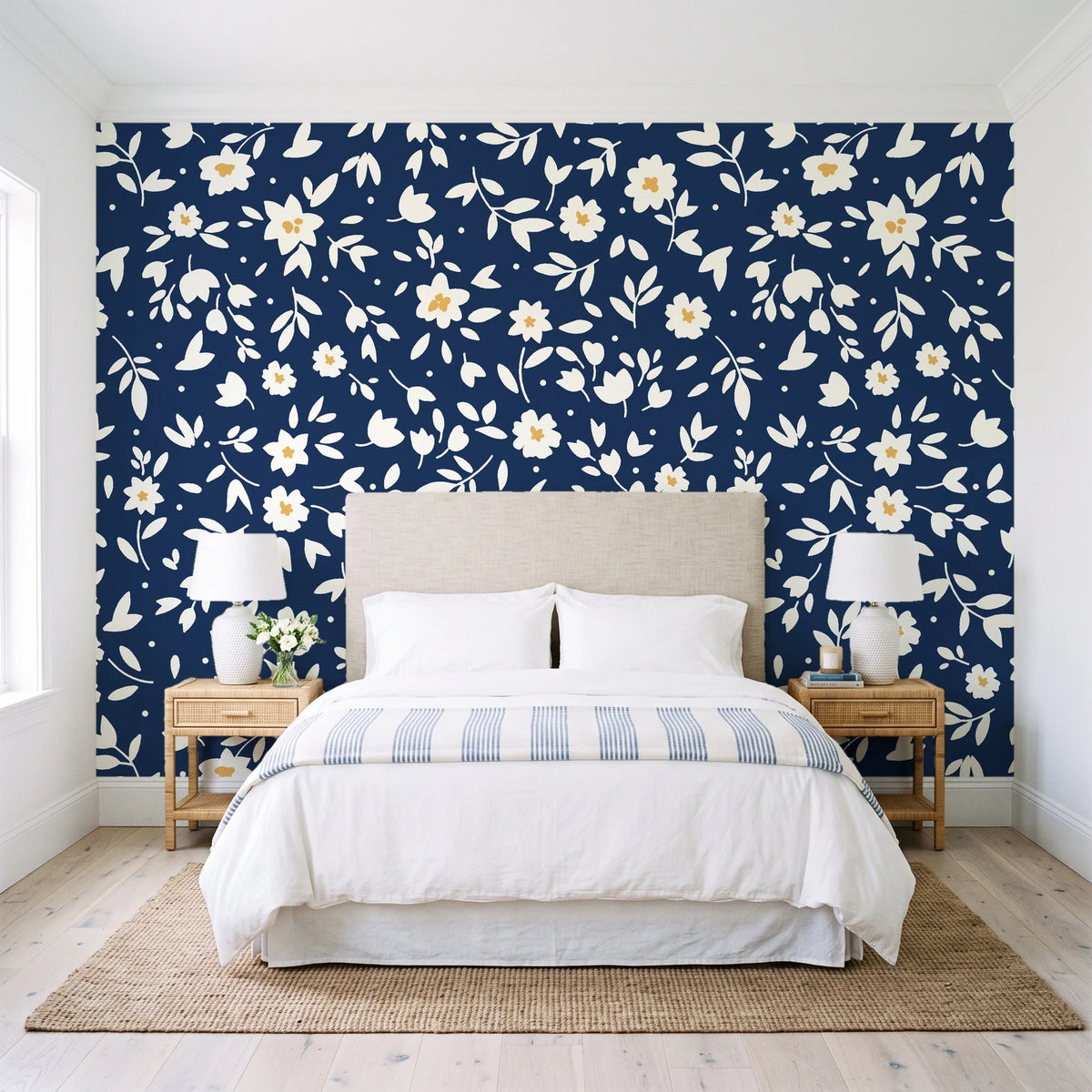 First Bloom Navy ditsy floral wallpaper behind a queen bed in a bright coastal bedroom