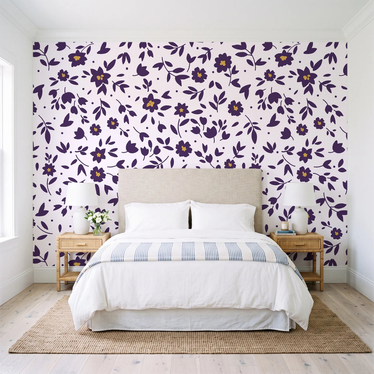 First Bloom Plum ditsy floral wallpaper behind a queen bed in a bright coastal bedroom