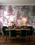 Frost & Fable Burgundy woodland toile wallpaper in a dark moody dining room with a candlelit table