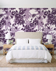 Frost Garden Veil Plum floral wallpaper behind a queen bed in a bright coastal bedroom