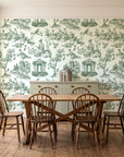 Garden Folly Sage pastoral toile wallpaper in a farmhouse dining room with a sage sideboard and rustic trestle table