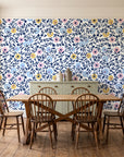 Garden Reverie Midnight floral wallpaper in a farmhouse dining room with a sage sideboard and rustic trestle table