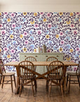 Garden Reverie Plum floral wallpaper in a farmhouse dining room with a sage sideboard and rustic trestle table