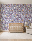 Garden Reverie Plum floral wallpaper in a calm, light-filled nursery