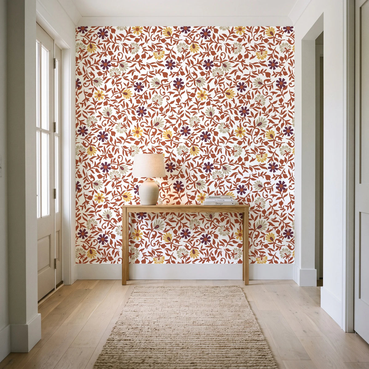 Garden Reverie Terracotta floral wallpaper behind a console table in a light entry hallway