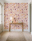 Garden Reverie Terracotta floral wallpaper behind a console table in a light entry hallway