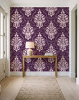 Gentlebotan Plum botanical damask wallpaper behind a console table in a light entry hallway