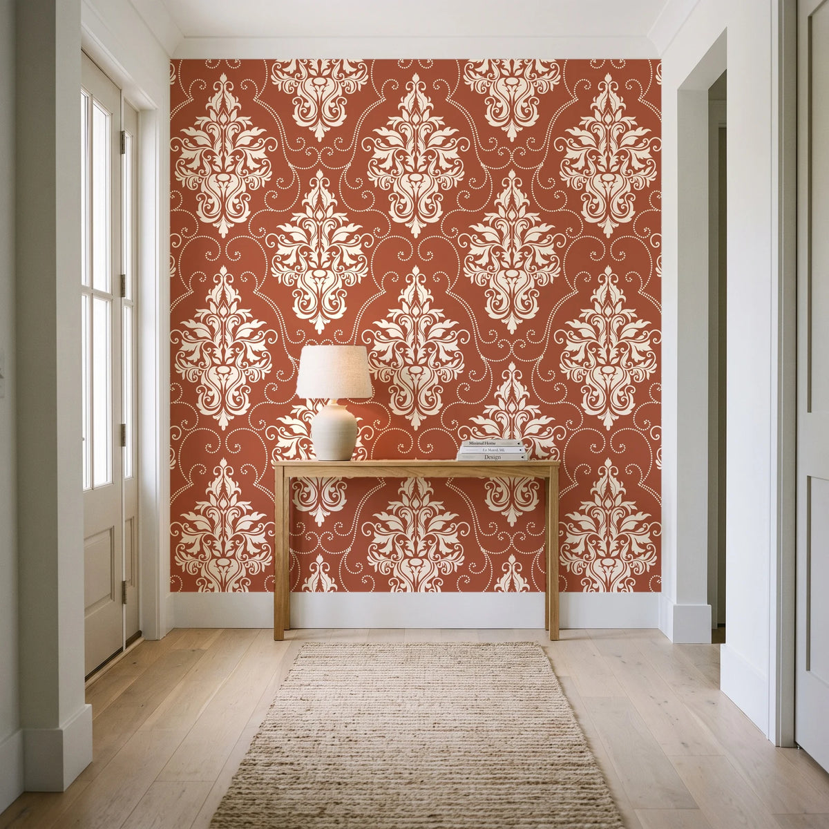 Gentlebotan Terracotta botanical damask wallpaper behind a console table in a light entry hallway
