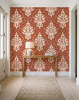 Gentlebotan Terracotta botanical damask wallpaper behind a console table in a light entry hallway