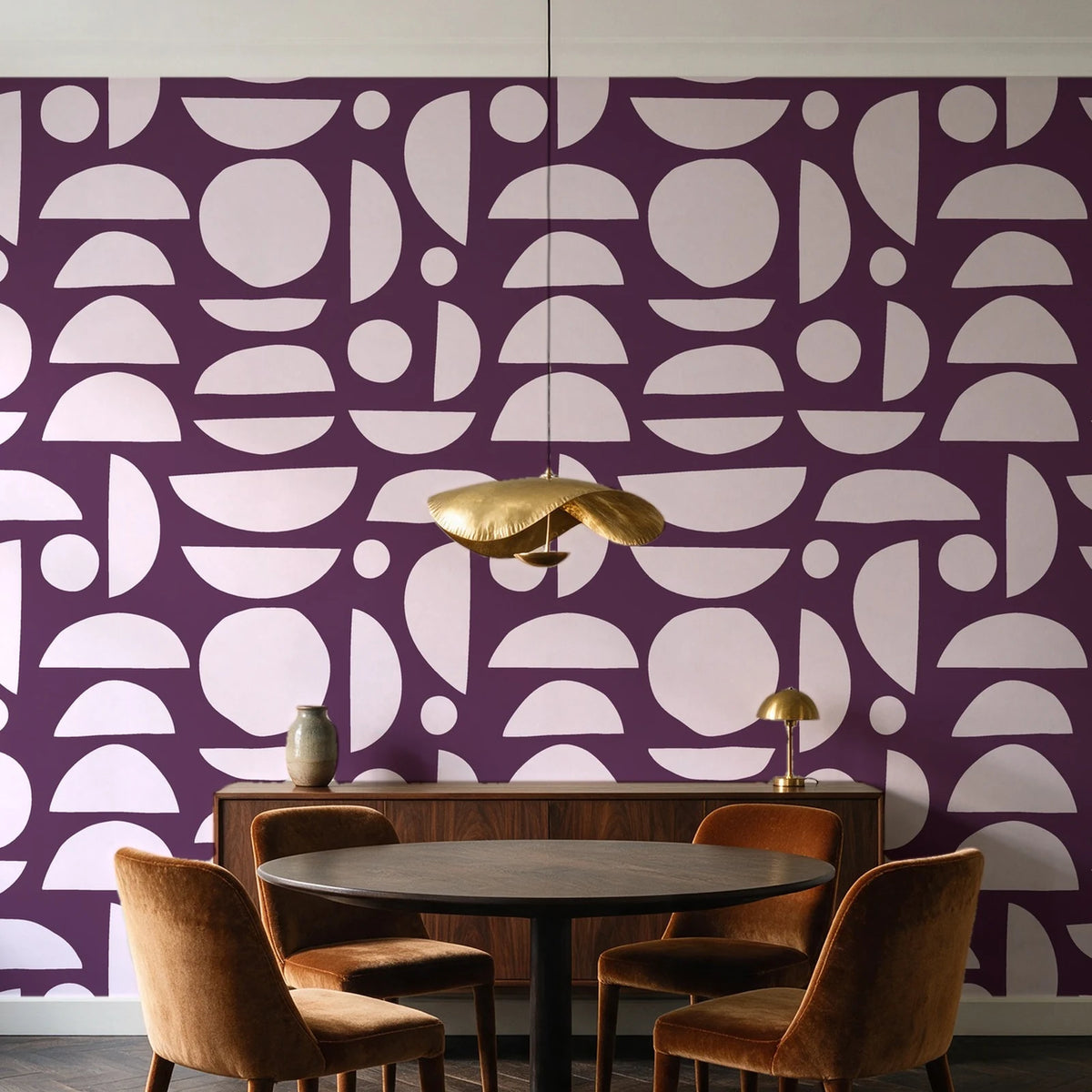 Geo Eclipse Plum organic shapes wallpaper behind a walnut credenza and round table in an elegant dining room