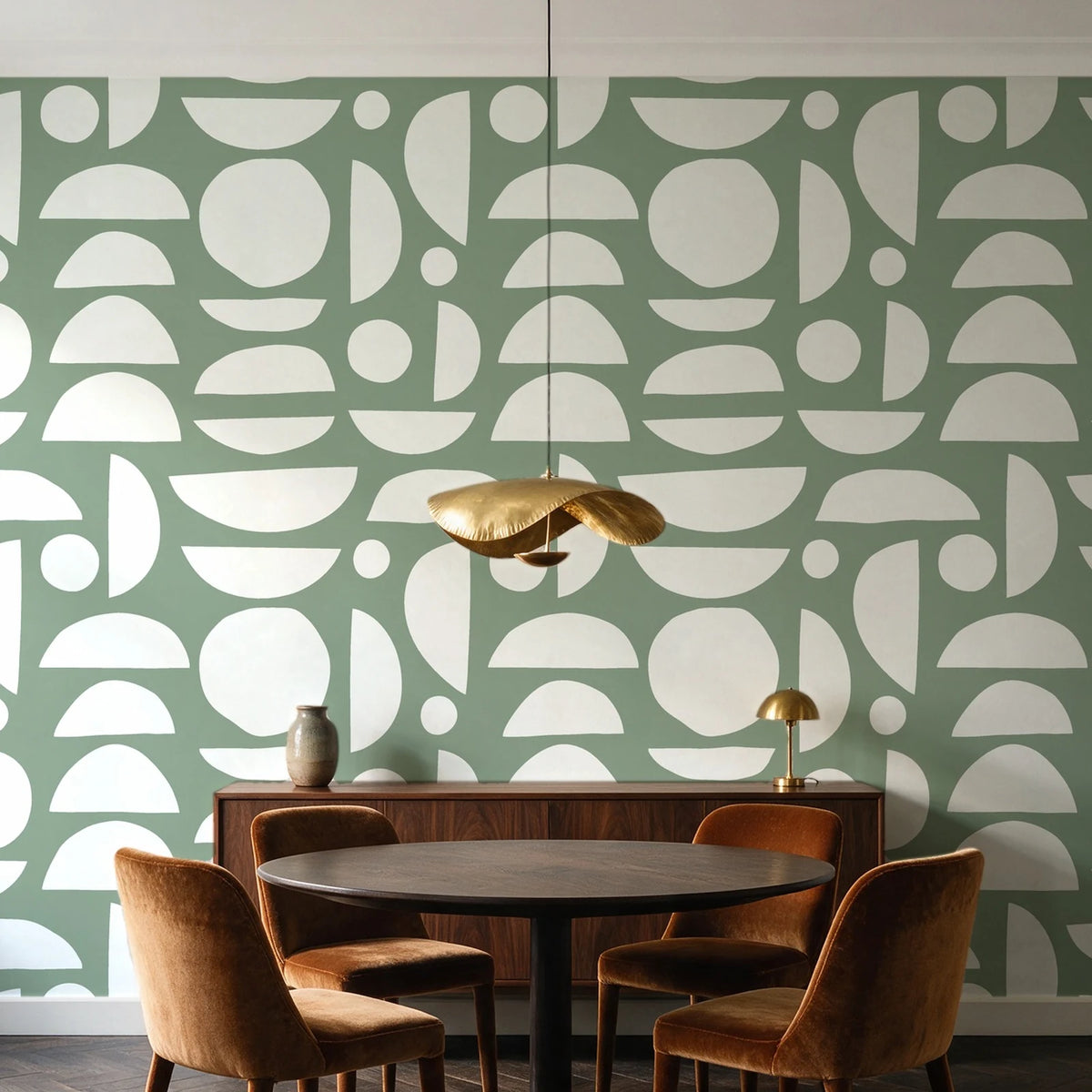 Geo Eclipse Sage organic shapes wallpaper behind a walnut credenza and round table in an elegant dining room