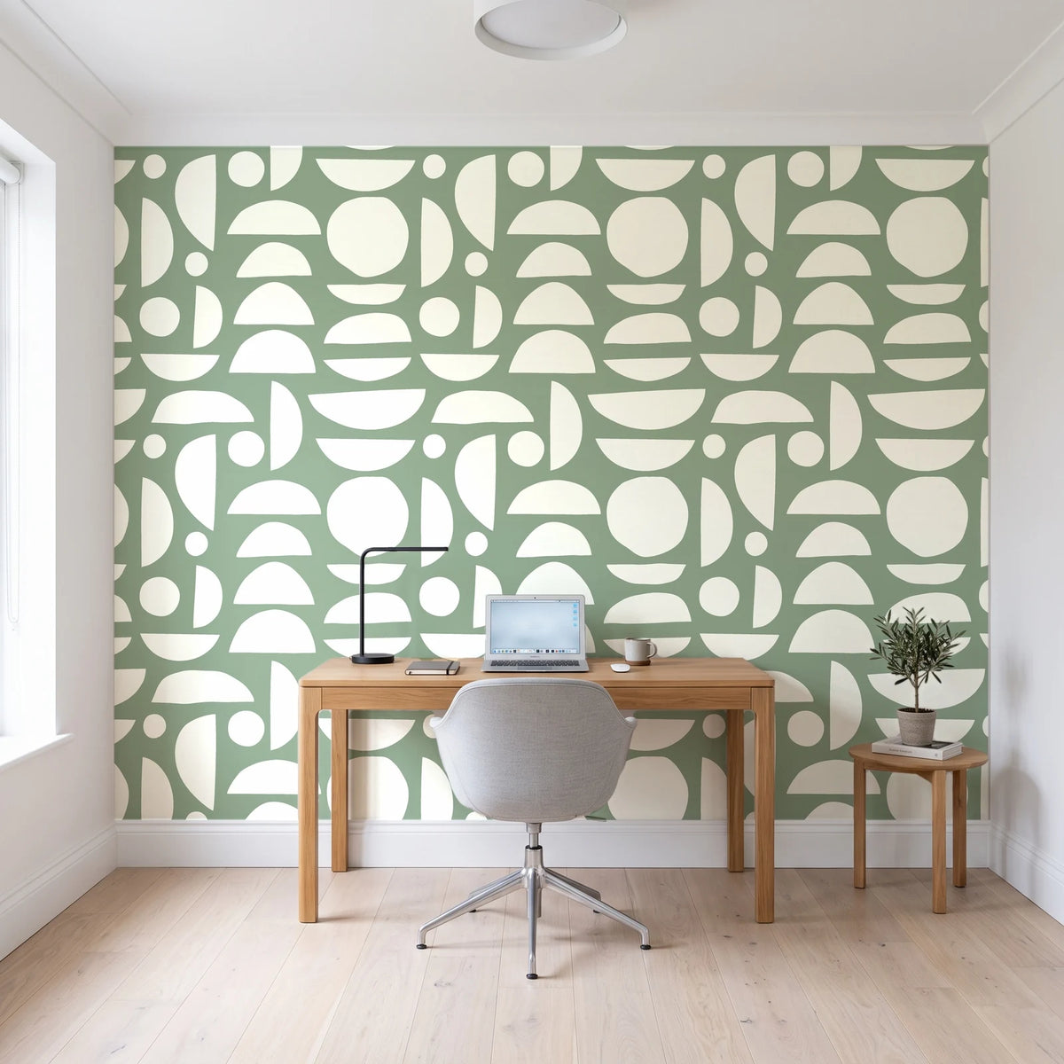 Geo Eclipse Sage organic shapes wallpaper behind a modern oak desk in a bright home office