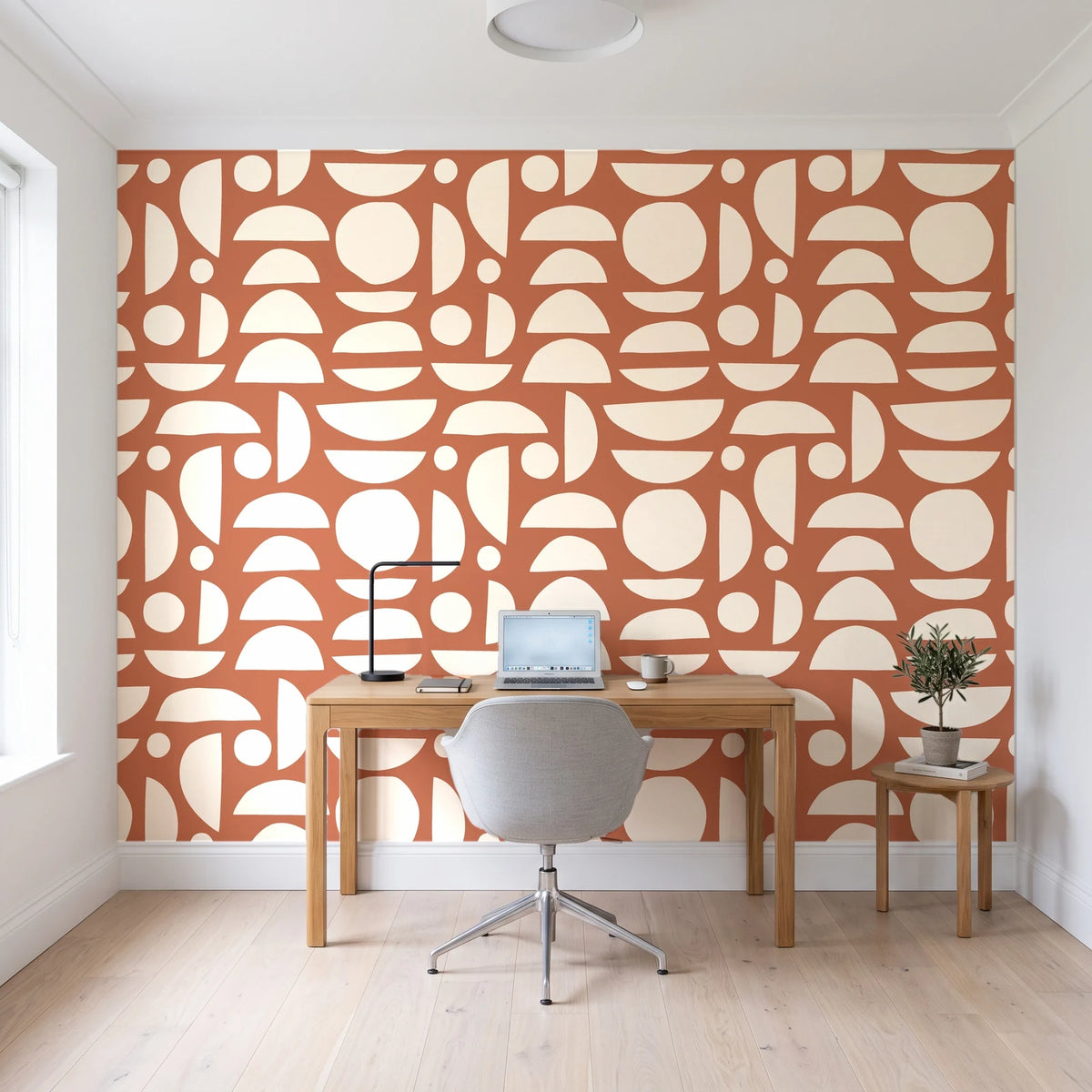 Geo Eclipse Terracotta organic shapes wallpaper behind a modern oak desk in a bright home office