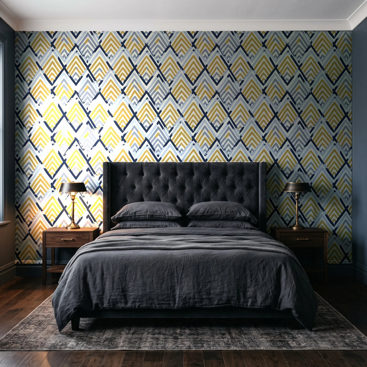 Gilded Crossing Navy chevron geometric wallpaper behind a tufted headboard in a dark, moody bedroom